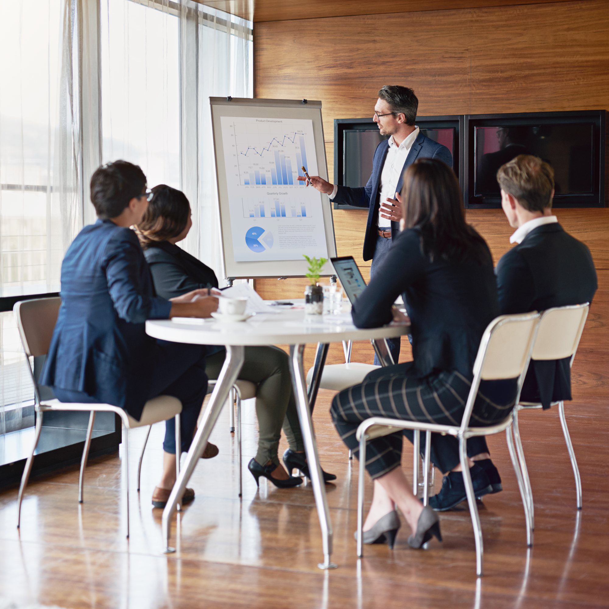 Business meeting with charts and graphs presentation.